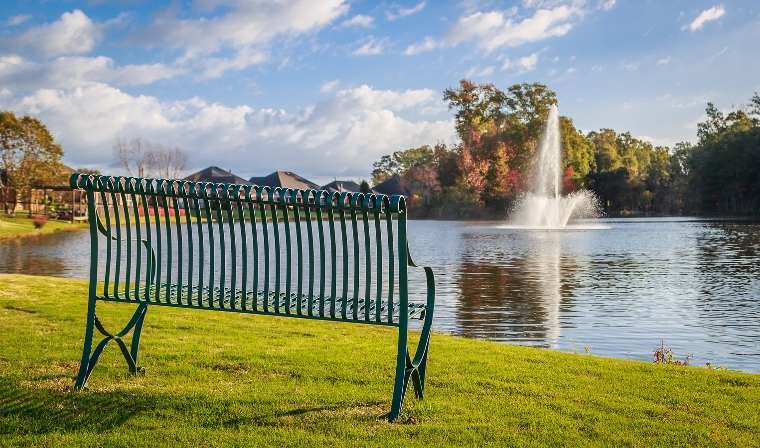 Bench next to community pond with fountain